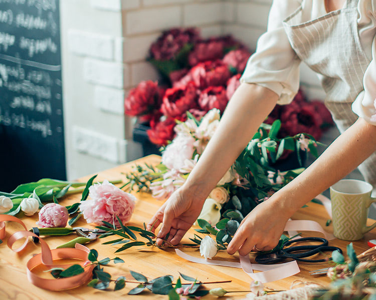 A designer carefully prepares her next arrangement