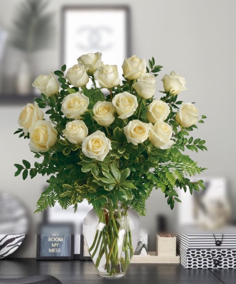 One dozen white roses in a clear glass vase